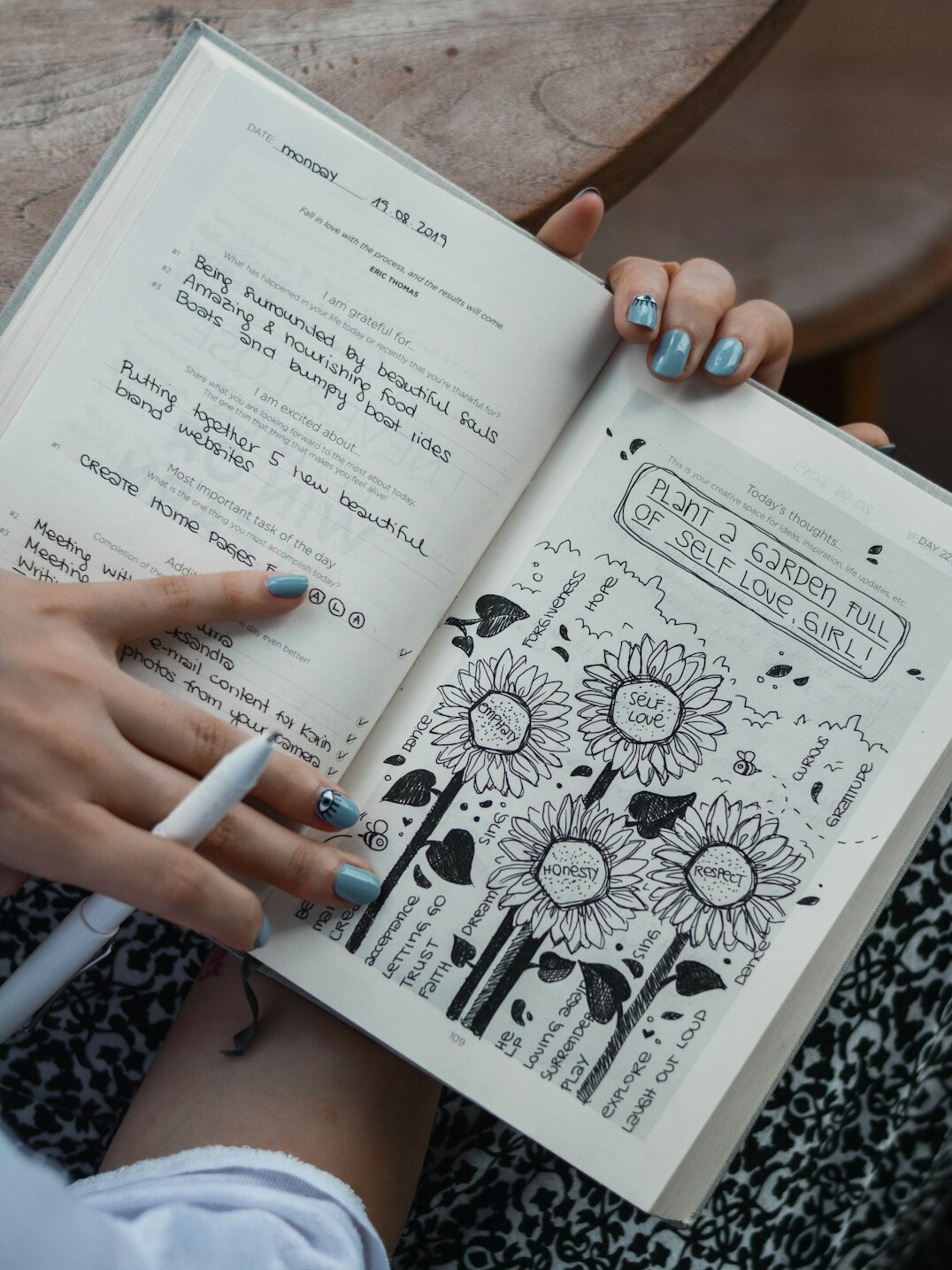 person writing notes in journal